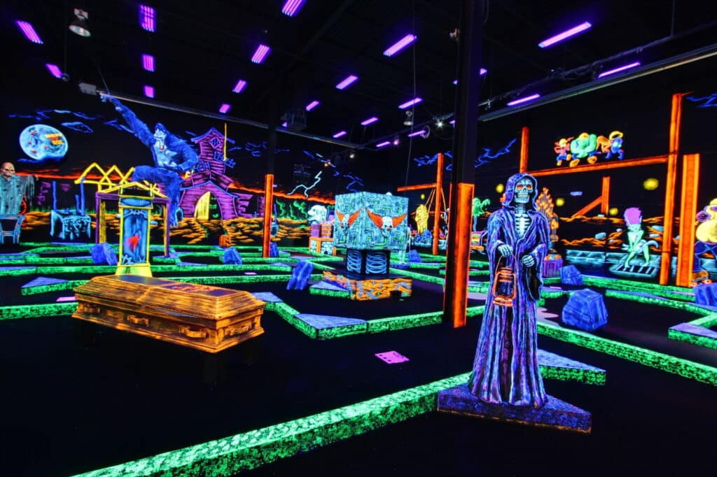Birthday Party Place For Kids 1 Neon decorations at a glow-in-the-dark indoor mini golf course.